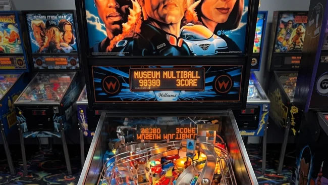 Máquina de pinball Demolition Man da Williams de 1994 com destaque para o campo de jogo widebody e as alças laterais.